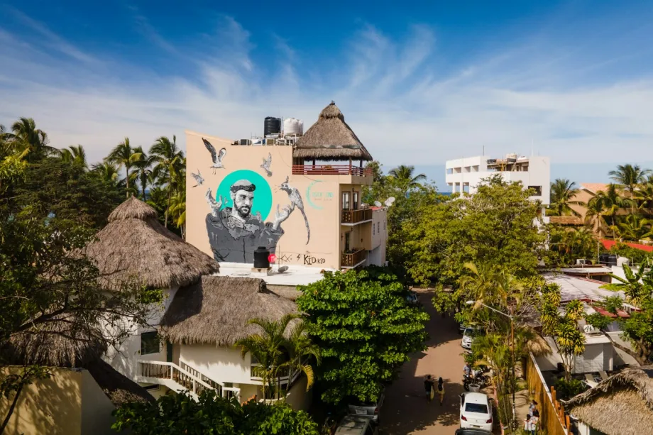 White building surrounded by green trees in San Pancho, Mexico